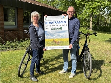 Eine Frau und ein Mann halten ein Plakat hoch, auf dem groß das Wort "Stadtradeln" zu lesen ist. Loxstedts Bürgermeister Detlef Wellbrock und Anne Böttjer, Klimaschutzmanagerin der Gemeinde Loxstedt, freuen sich schon auf den Start der diesjährigen Stadtradeln-Aktion und hoffen auf viele Mitradelnde.