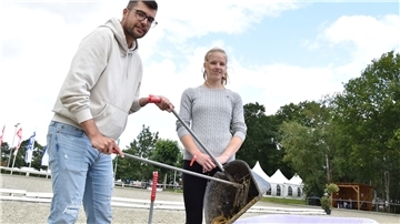 Anna (15) ist nicht das erste Mal bei den Elmloher Reitertagen als Abäpplerin unterwegs. Sie bringt Florian Zinn bei, wie man Pferdeäpfel richtig einsammelt und entsorgt.