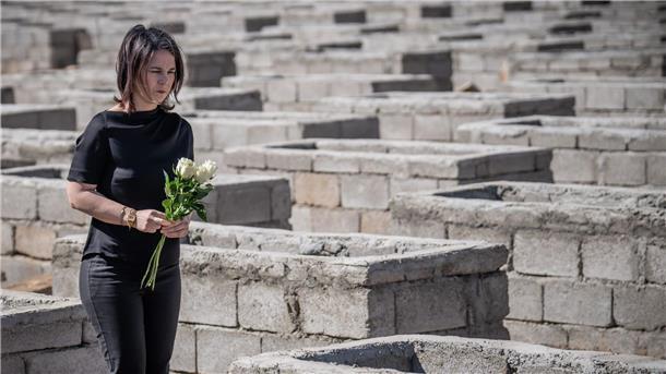 Annalena Baerbock legt Blumen am Friedhof von Kocho nieder.