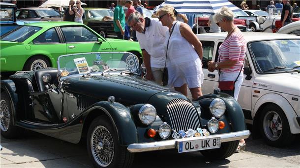 Menschen gucken sich Oldtimer an