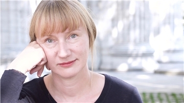 Frau, die ihren Kopf auf die Hand stützt.
