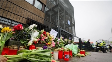 Blumen und Kerzen vor dem Eingangsbereich eines Gemeindehauses der Zeugen Jehovas. Nach der Amoktat in den Räumen der Zeugen Jehovas in Hamburg dauern die Ermittlungen weiter an.