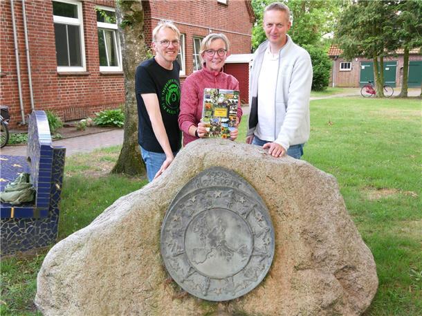 Bürgermeisterin Heidi Stelljes zwischen Florian Müller (links) und Holger Meyer freuen sich über die neu gestaltete Broschüre für den Bezirksentscheid „Unser Dorf hat Zukunft“.
