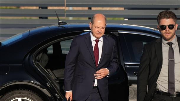 Personenschützer können nicht alles verhindern Bundeskanzler Olaf Scholz (l, SPD) kommt zum Start einer zweitägigen Reise auf dem militärischen Teil des Flughafens Berlin Brandenburg BER an und steigt aus einer Limousine.