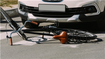 close up view of broken bicycle and car on road, car accident concept