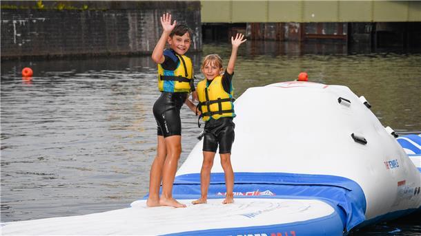Wassersport bei der SAiL 2025: Im Hafenbecken geht‘s so richtig rund Das Blue Bay aus Spaden bietet zur Sail Wassersport im Alten Hafen an. Mit dem Aquapark haben Smilla und Bo Spaß.