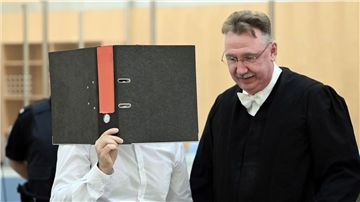 Der Angeklagte wartet mit seinem Anwalt im Gerichtssaal des Oberlandesgerichtes.