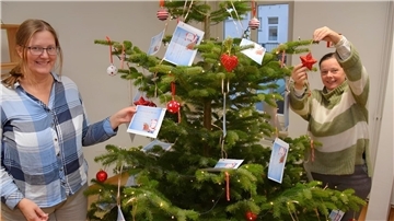 Zwei Frauen und ein geschmückter Weihnachtsbaum