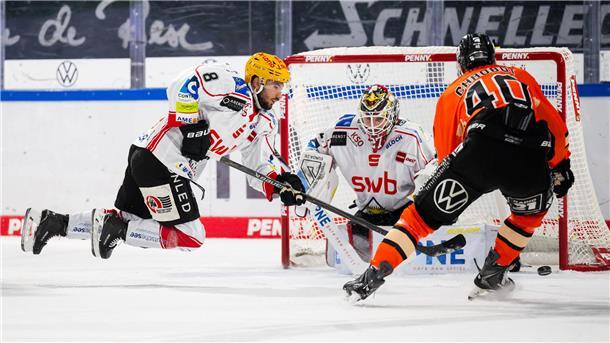 Drei Tore von Urbas: Pinguins gewinnen in Wolfsburg Ein Eishockey-Torhüter und zwei Spieler in Aktion