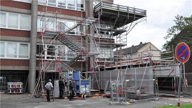 Der Kuddelmuddel-Turm: Außer für die Treppe zahlt die Stadt auch Miete für das Gerüst mit Auffangplattform, das verhindern soll, dass Betonbrocken vom Turm auf die Walther-Rathenau-Straße oder den Eingangsbereich zum Rathausturm fallen.