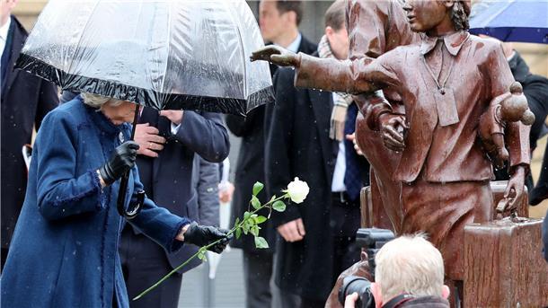 Hamburg bereitet Charles und Camilla jubelnden Empfang Die britische Königsgemahlin Camilla (l) legt eine weiße Rose am Denkmal „Kindertransport - Der letzte Abschied“ ab.