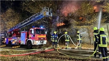 Feuerwehrleute löschen einen Haus-Brand