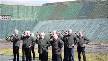 Die Jagdhornbläser der Jägerschaft Zeven spielen zur offiziellen Einweihung des Schießstandes vor der Kulisse des 22 Meter hohen Lärmschutzwalls.