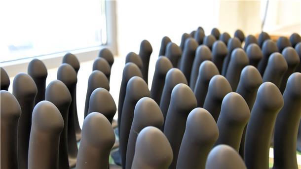 Schwarze Dildos aus Silikon stehen in Reih und Glied.