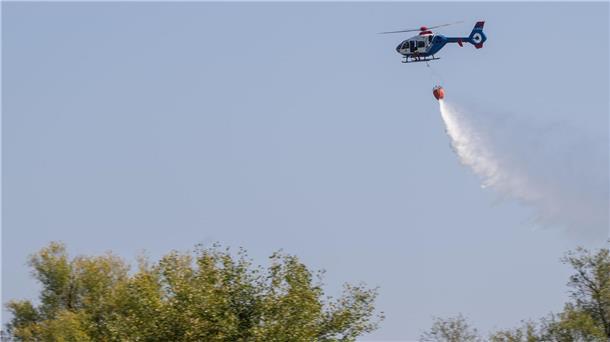 Feuerwehren üben Einsatz mit Hubschrauber Ein Hubschrauber der Polizei wirft bei einer Übung zur Waldbrandbekämpfung Löschwasser ab.