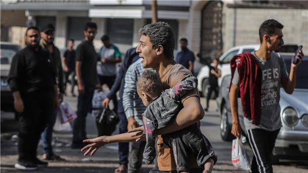 UN beklagen Tausende getötete Kinder im Gazastreifen Ein Mann trägt nach einem israelischen Luftangriff auf Gaza-Stadt ein verletztes Kind auf dem Arm.