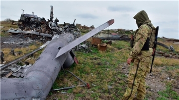 Ein ukrainischer Soldat betrachtet auf der Schlangeninsel im Schwarzen Meer ein zerstörtes russisches Militärflugzeug.