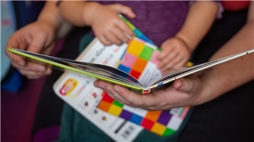 Nahaufnahme von Kinderhänden, die einige Bücher halten