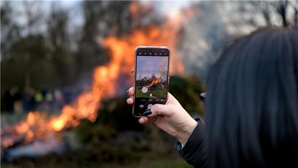 Keine Randale: Polizei zieht positives Fazit nach Osterfeuern im Cuxland Eine Besucherin filmt ein Osterfeuer - so friedlich verhielten sich offenbar alle.