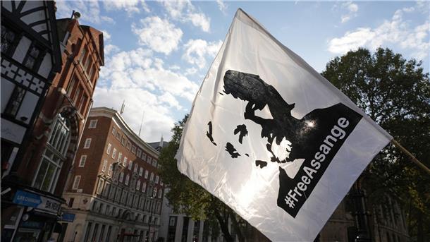 Eine Fahne mit dem Konterfei von Julian Assange wird bei einer Demonstration vor dem Royal Courts of Justice in London geschwenkt.