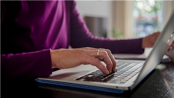 Eine Frau arbeitet an einem Laptop. Vor allem Frauen arbeiten wegen der Betreuung von Angehörigen in Teilzeit (Symbolbild).