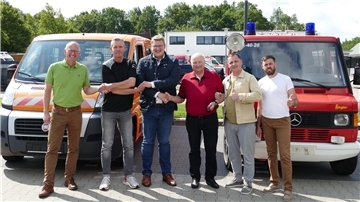 Einen Rundum-Handschlag als Dank vor den gespendeten Fahrzeugen