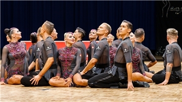 Tänzerinnen und Tänzer des A-Teams der TSG Bremerhaven sitzen auf dem Fußboden.