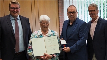 Erika Diehl (mit Ernennungsurkunde) zusammen mit (von links) Schiffdorfs Bürgermeister Henrik Wärner, Landrat Thorsten Krüger (mit Verdienstmedaille) und Ex-Bürgermeister Claus Wirth.