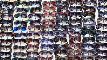 Eine große Sammlung verschiedener Sport-Sonnenbrillen in diversen Farben.