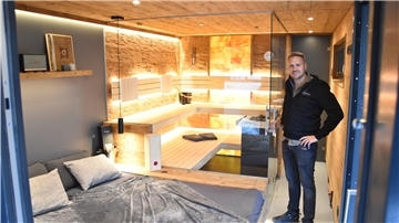 Ein Mann steht in einer Sauna.