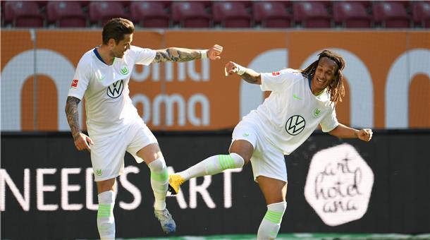 Haben die Abstandsregeln beim Torjubel eingehalten: Wolfsburgs Daniel Ginczek (l) feiert sein Tor zum 1:2 mit Wolfsburgs Kevin Mbabu.
