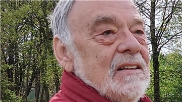 Ein älterer Mann mit Bart in einer roten Jacke. Helmut Heyen ist zu einer Benefiz-Lesung im „König von Griechenland" in Ovelgönne zu Gast.