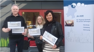 Hilko Schütte, Vorstandsmitglied der Jade-Wirtschaftsraum-Regionalstiftung, vergibt die Schecks an die Leiterin des Kindergartens, Frau Katja Hofschildt und an Frau Sandra Janßen, zweite Vorsitzende des Shantychors, die Hafenperlen.