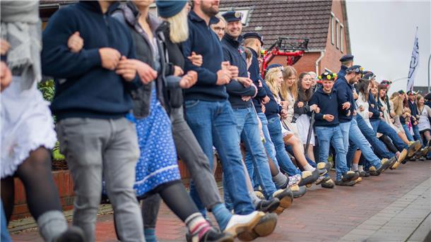 Wie es ist, das erste Mal beim Holtschentanz dabei zu sein In der Ortsmitte reihten sich die Paare für eine Schunkelrunde auf dem Gehweg auf.