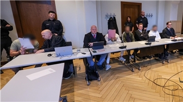 Männer an Tischen im Gerichtssaal