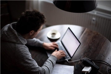 Mann am Computer Internet Betrug