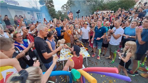 Deichmann-Finish mit Gänsehaut-Atmospäre: „Geil war’s“ Jonas Deichmann stößt kurz vor dem Zieleinlauf schon mal an.