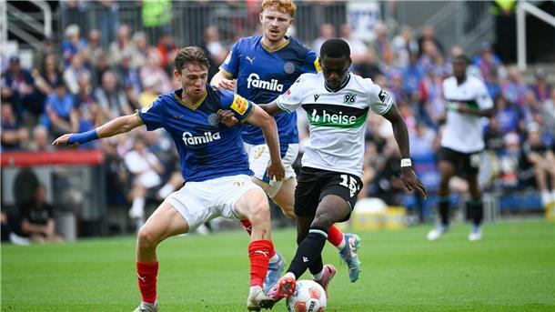 Hannover dreht das Spiel und gewinnt bei Holstein Kiel Kiels Magnus Knudsen (l) im Duell mit dem Hannoveraner Noel Aseko.
