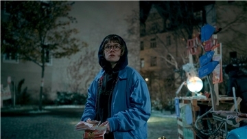 Luise Kogan (Lea Drinda) verteilt Flyerin einer Szene des Thrillers „Wer wir sind“ .