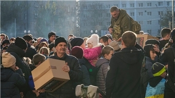 Menschen erhalten humanitäre Hilfe auf einem zentralen Platz in Cherson. Nach den wohl massivsten russischen Raketenangriffen auf die ukrainische Energieinfrastruktur seit Kriegsbeginn hat Kiew die Situation als „kritisch“ bezeichnet.