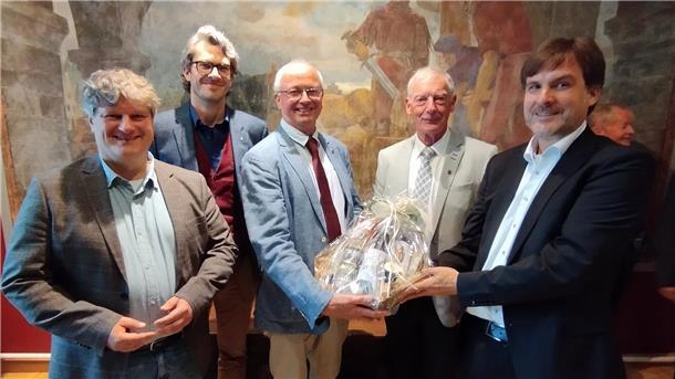 Nordenhamer Museumschef geht in Ruhestand: So lief die Verabschiedung Mit einem Präsentkorb dankte Bürgermeister Nils Siemen (rechts) dem scheidenden Museumsleiter Dr. Timothy Saunders (Mitte).