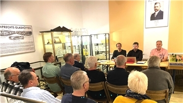 Mitgliederversammlung unter den Augen der ehrwürdigen Unternehmerlegende Hermann Lamprecht. Ralf Rimkus (rechts) und Sandy Blank (links) nehmen am Vorstandstisch Jendrik Volkmann in ihre Mitte. Der neue Vorsitzende bekam Lob und Anerkennung, weil er dem Verein und dem Museum mit seinem großen ehrenamtlichen Engagement neuen Schwung verliehen hat.