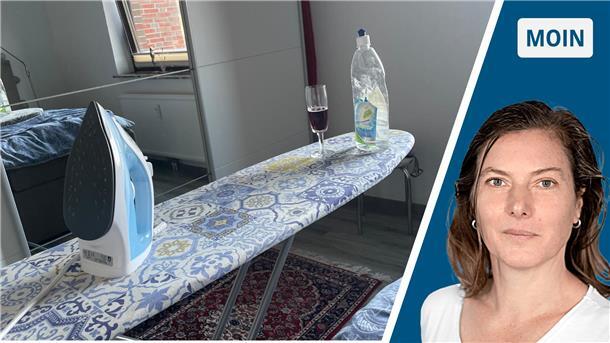 Ein Bügelbrett mit Bügeleisen und einem Glas Rotwein.