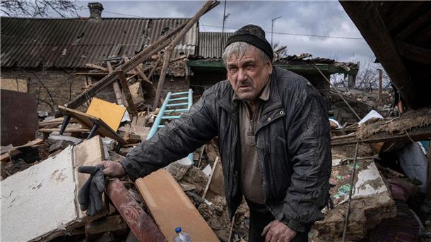 Sondersendungen zu einem Jahr Krieg in der Ukraine Mykola Volenshak sieht sich sein von einer russischen Rakete zerstörtes Haus an, während er versucht, Dokumente unter den Trümmern zu finden.