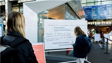 Reisende informieren sich im Berliner Hauptbahnhof über den bevorstehenden Streik.