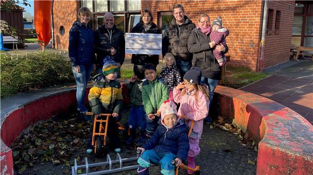 Scheckübergabe an der Kita Tossens. Die Kinder sind bereits dabei, das neue Spielzeug auszuprobieren.