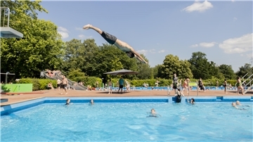 Ein Junge springt ins Wasser. 