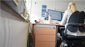 Eine Frau sitzt im Büro.