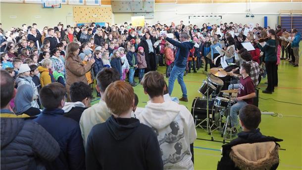 Stimmgewaltiges Zeichen für den Frieden: Musiklehrer Erik Middelberg dirigiert den Schülerchor, die Schülerband sorgt für den Sound.