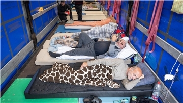 Trucker aus Georgien liegen auf einem Matratzenlager auf der Ladefläche eines Lkw. Sie sind in einen Hungerstreik getreten.